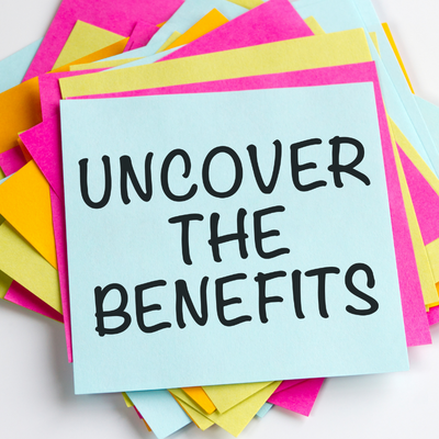 Post-it notes with 'Uncover the benefits' written onto the top page